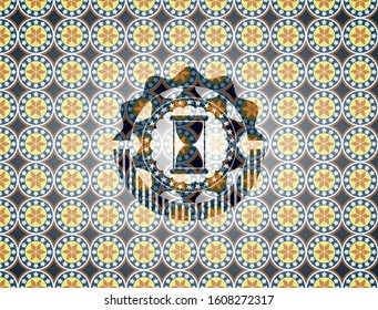 hourglass icon inside arabic badge background. Arabesque decoration.