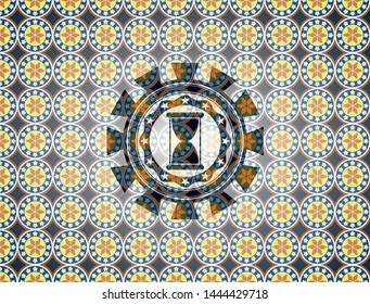 hourglass icon inside arabic style badge. Arabesque decoration.