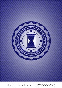 hourglass icon inside badge with denim background