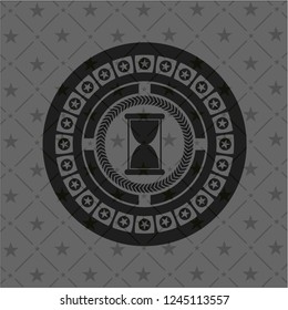 hourglass icon inside black badge