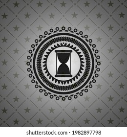 hourglass icon inside black badge. 
