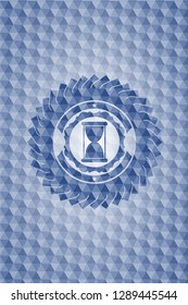 hourglass icon inside blue badge with geometric background.