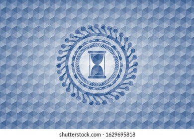 hourglass icon inside blue polygonal emblem.