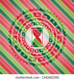 hourglass icon inside christmas badge.
