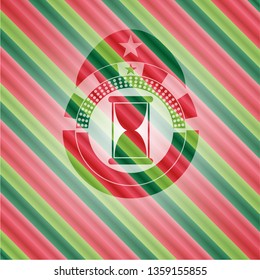 hourglass icon inside christmas badge.