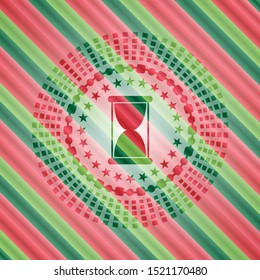 hourglass icon inside christmas emblem.