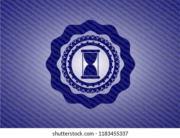 hourglass icon inside denim background