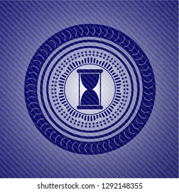 hourglass icon inside denim background