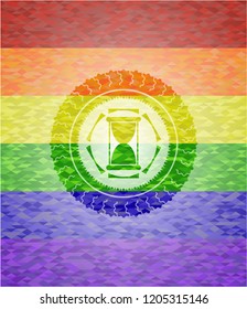 hourglass icon inside emblem on mosaic background with the colors of the LGBT flag