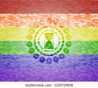 hourglass icon inside emblem on mosaic background with the colors of the LGBT flag