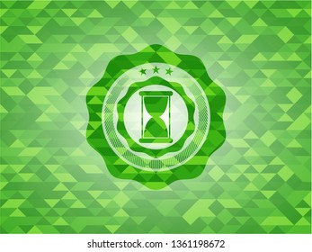 hourglass icon inside green emblem with mosaic ecological style background