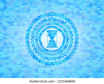 hourglass icon inside light blue mosaic emblem