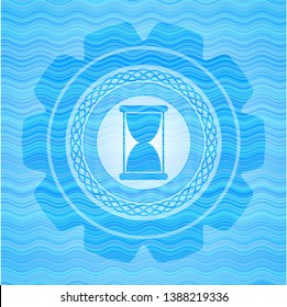 hourglass icon inside light blue water wave style emblem.