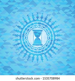 hourglass icon inside light blue emblem with mosaic background