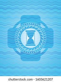 hourglass icon inside light blue water badge background.