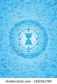 hourglass icon inside realistic light blue mosaic emblem