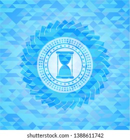 hourglass icon inside realistic sky blue emblem. Mosaic background