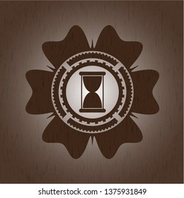 hourglass icon inside realistic wooden emblem