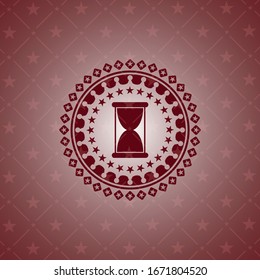hourglass icon inside red emblem