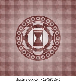 hourglass icon inside red seamless geometric badge.