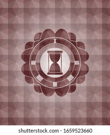 hourglass icon inside red seamless geometric badge.