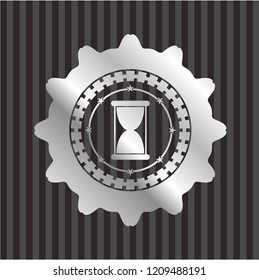 hourglass icon inside silver shiny emblem