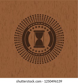 hourglass icon inside vintage wood emblem