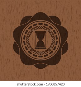 hourglass icon inside wood badge or emblem