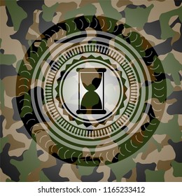 hourglass icon on camouflage texture