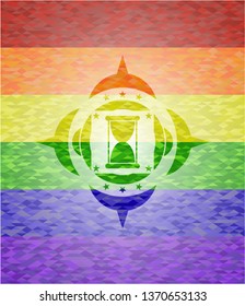 hourglass icon on mosaic background with the colors of the LGBT flag