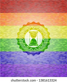 hourglass icon on mosaic background with the colors of the LGBT flag
