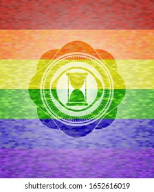 hourglass icon on mosaic background with the colors of the LGBT flag