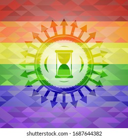 hourglass icon on mosaic background with the colors of the LGBT flag
