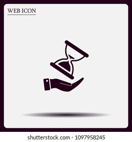 An hourglass on the hand. Vector icon.