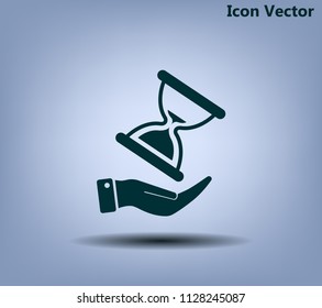 An hourglass on the hand. Vector icon.
