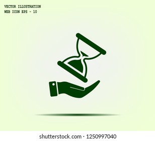 An hourglass on the hand. Vector icon.