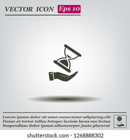 An hourglass on the hand. Vector icon.