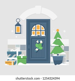 House door decoration for the Christmas holidays.Frozen windows with light inside. Cozy winter exterior with snow falling.