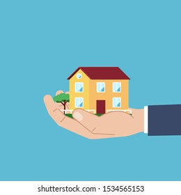 House is in human hand. The concept of purchase, rental housing. Vector illustration in flat style.