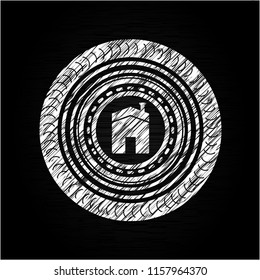 house icon inside chalk emblem written on a blackboard