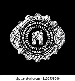 house icon inside chalk emblem written on a blackboard