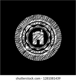 house icon inside chalk emblem written on a blackboard