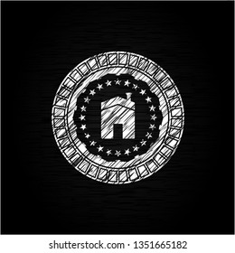 house icon inside chalk emblem written on a blackboard