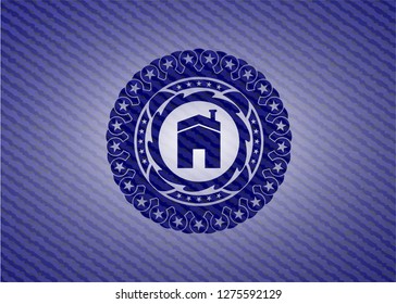house icon inside emblem with denim texture