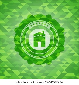 house icon inside green emblem with mosaic background