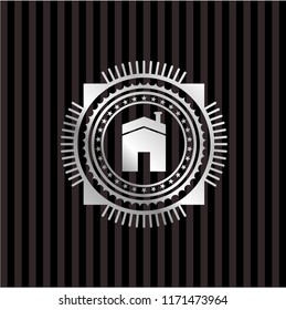 house icon inside silver emblem