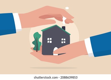 House insurance, real estate or property protection, home security concept, house in businessman palm with other hand cover to protect as insurance coverage.