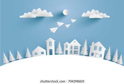 a house on a snow hill and there are paper planes on it with paper and craft art designs