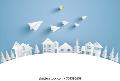 a house on a snow hill and there are paper planes on it with paper and craft art designs