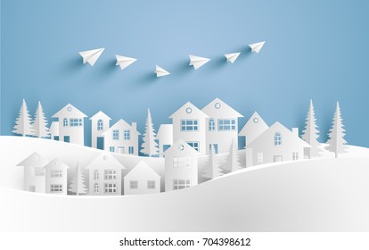 a house on a snow hill and there are paper planes on it with paper and craft art designs